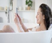millennial girl bath mobile phone having webcam video conversation enjoy bodycare bathroom attractive young mixed 222250245.jpg from new webcam lady bath