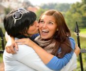 mother kissing her daughter happy embrace outdoors 26697895.jpg from mom kissing