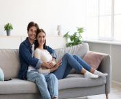 smiling happy young caucasian husband hugging wife enjoying tender moment sitting sofa free time living room interior 235806523.jpg from young wife enjoying with her husband and fucked in many positions