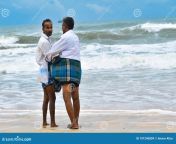 two senior men wearing blue lungi talking having fun panambur beach where heavy tides forming due to high wind pressure 191240809.jpg from daddy lungi