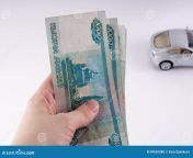 hand holding pile thousand dollar ruble notes russian cu currency white background 89601886.jpg from russian cu