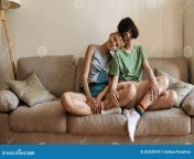 homosexual couple lesbian women relaxing sitting together couch home spending time indoors front view selective focus 203349339.jpg from how lesbians spend time indoor 100 1634