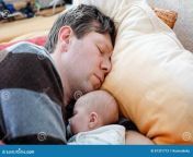 middle aged father sleeping near his newborn baby daughter young dad cuddling girl home happy parenthood carefree 87391773.jpg from father sleeping