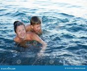 mother son bathing sea having fun laughing 76191420.jpg from russian granny bathing with son