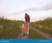 mom teaches daughter to ride bike country road field sunflowers small child learns mother plays her little 155600443.jpg from step daughter learning to ride c