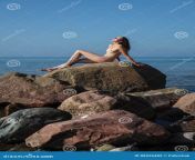 naked girl outdoors enjoying nature beautiful young nude woman sits large rock against sea lady nude perfect body 88526482.jpg from naked enjoying full body