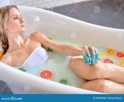 beautiful sexy woman take bath benefits milk baths flowers fruits skin body attractive slender lady lying 235590104.jpg from beautiful take a bath