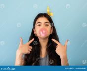 funny indian teen girl blowing bubble sugar free chewing gum pointing over blue studio background adorable youth 227964283.jpg from bubbly young indian babe enjoyed by boyfriend on cam