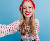 excited blonde girl beret taking selfie blue wall carefree young woman striped shirt 1.jpg from selfie for