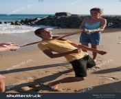 stock photo group of cheerful friends ing limbo game on beach summer vacation concept 2135246943.jpg from nudist beach family limbo game jpg nudist family nude lss ampcd131amphlidampctclnkampglid