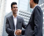 young smiling indian businessman making handshake with partner 8087 2247.jpg from indian shaking