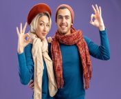 smiling young couple wearing hat with scarf valentine s day showing okay gesture isolated blue background 141793 110413.jpg from marathi man woman s
