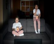 two sister girls are watching tv show tv with interest couch dark room eveni 114160 1245.jpg from two sister premium show on tango