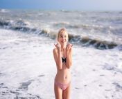 happy young blonde girl having fun dream beach with big white waves 88194 1067.jpg from blonde having fun before the shower by stripping naked on tiktok