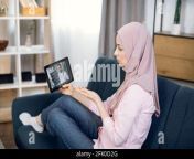 close up of young sick muslim woman talking with her doctor through video chat on tablet pc showing him blister with pills man doctor talking to patient about results of x ray and medicines dosage 2fk0d2g.jpg from owaman xxx video ductor