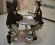deputies talking jailhouse table.jpg from co officer