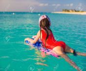27890699 little cute girl swimming on a surfboard in the turquoise sea.jpg from best pp ru