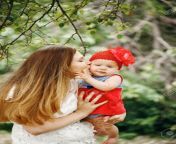 56564718 young mother kissing her cute baby in funny red hat.jpg from funny cute mom kiss