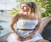 154257872 cute young blonde posing sitting on a background of a bridge dressed in a white dress.jpg from nice blonde posing