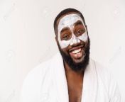127842985 young african american guy applying face cream on white background portrait of a young happy smiling.jpg from black guy crea