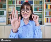 depositphotos 576490624 stock photo female teacher library talking looking.jpg from webcam in library