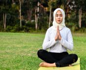 young asian muslim woman sitting on the grass enjoying meditation photo.jpg from wasmo asia mudlim