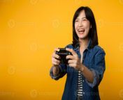 portrait young asian woman with happy success smile wearing denim clothes holding joystick controller and playing video game fun and relax hobby entertainment lifestyle concept photo.jpg from young asians playing flashing and masturbating on camera