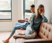 c55f7c70e354836540b8ffc3298ff11b woman looks stressed while sitting next to her partner on the couch l sm.jpg from white cheats on boyfriend while he’s at work