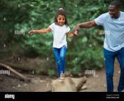 father helping daughter balance on fallen log in woods 2cwxa3r.jpg from tep father and daughter