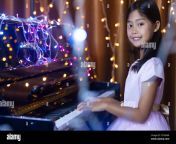 a cute asian schoolgirl is playing the piano in a room decorated with flashing lights 2c7ax6m.jpg from young asians playing flashing and masturbating on camera