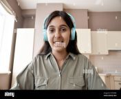 indian woman student teacher wearing headphones looking at web cam 2c87dwr.jpg from web cam indian