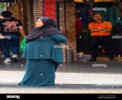 woman standing in the street wearing islamic headwear hijab or tudung kuala lumpur malaysia 2b8kfg8.jpg from tudung