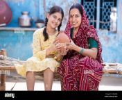 portrait of happy rural indian mother and adorable daughter holding piggy bank while sitting on traditional bed at village home cute little girl coll 2gcj4k8.jpg from indian village mom and hi sex videos free downloadesi ra