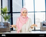 video meeting with a young muslim woman wearing hijab sitting at the desk in the office video screen webcam view virtual conference with a diverse employees 2ey346c.jpg from webcam hijap