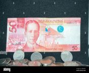 50 philippine peso paper bill above a pile of peso coins 2d8mx44.jpg from pešo nudis
