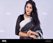 young indian woman wearing an elegant black saree looking at camera smiling happy grey background 2dcrjxt.jpg from www black saree pora sexy vabi video cona