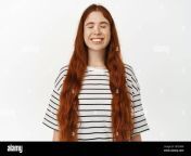image of beautiful redhead curvy woman with eyes closed dream of something with happy face smiling carefree picturing in her mind standing against 2g7e40w.jpg from curvy redheadx kos