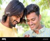 happy young indian gay couple looking at their photos on the phone outdoors 2fa4td0.jpg from new 2015 desi gay xn ma chale xxx sex