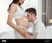 young husband kissing his pregnant wifes tummy in bedroom 2h2e4aj.jpg from husband wife belly kis