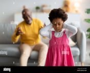 sad black little girl closes her ears and does not want to listen to swear old man in living room interior grandpa scolds naughty granddaughter rela 2h797er.jpg from naughty america old to young milf rape