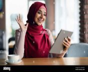 cheerful muslim woman in hijab having video chat using tablet 2h7hg73.jpg from hijab chat