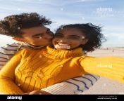 portrait of smiling biracial woman taking selfie of boyfriend hugging and kissing on cheek at beach 2hf514a.jpg from selfie for bf