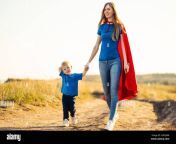 super mom and her son walk forward holding hands cheerful family a woman in a red raincoat as a superhero mom and son play superheroes during the d 2hfgj4m.jpg from www super mom and son xxxx video free download in kitchen with big bo