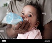 close up portrait of unrecognizable black man bottle feeding his baby with formula or pumped breastmilk 2j4ddxh.jpg from black man drinking breast milk