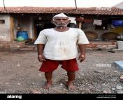 a beautiful portrait of an old south indian village man or farmer wearing marathi cap and standing in front of his farmhouse 2jkwj42.jpg from indian marathi villege jan