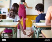two primary school children sneaking a note to each other while the teacher is teaching 2jg0pc9.jpg from www brazars com school xxx7 8 9 10