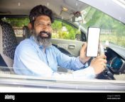 happy indian mature man sitting in car wearing seat belt show blank smart phone display to put advertisement 2m8btr3.jpg from indian driving car show