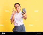 high school girl selfie using handphone with okay hand gesture 2mfnypb.jpg from scholl gril selfi shows