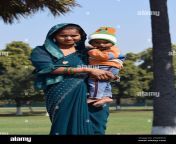 a young indian mother dressed in a traditional sari holding her young approximately 1 year old baby 2ngkfc0.jpg from www indian aunte and young xxx com