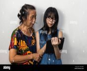 young asian women teach older women how to use modern internet technology tablets 2pth6rt.jpg from asian pth